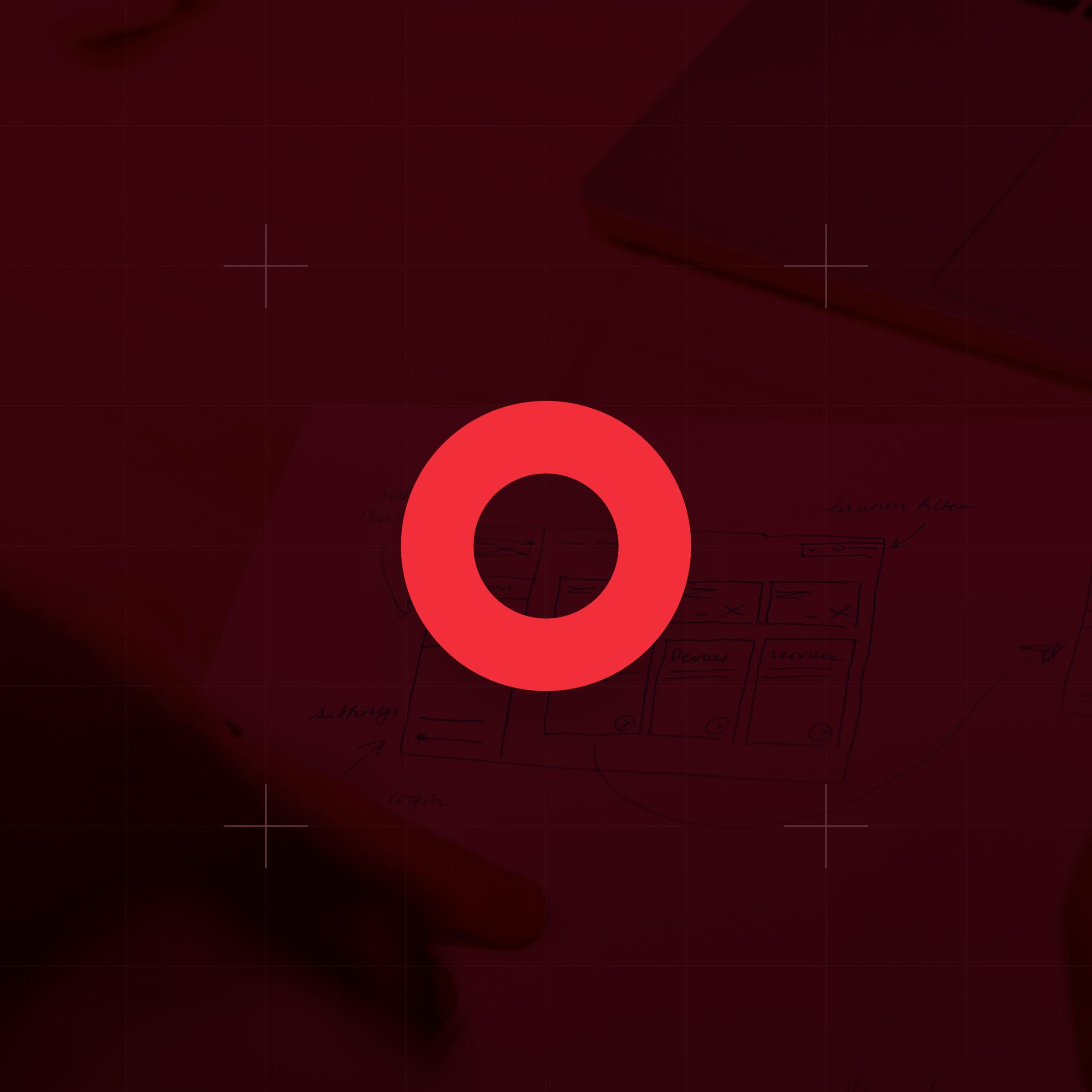 CodeFish Studio ring glyph over a red-tinted photo of hand-drawn interface sketches